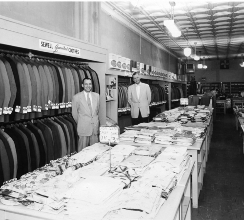 Ray Sewell, Sr. in an unknown store with apparel from the Ray Sewell Company