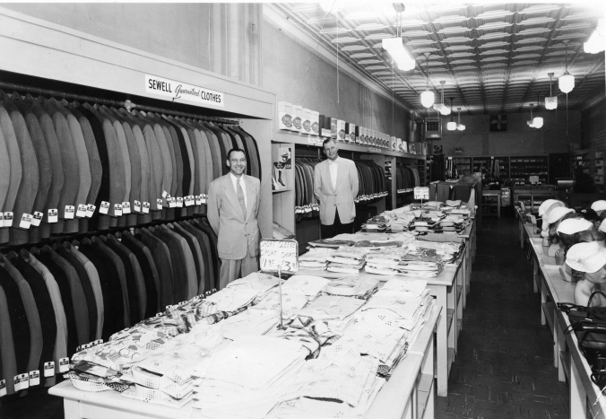 Ray Sewell, Sr. in an unknown store with apparel from the Ray Sewell Company
