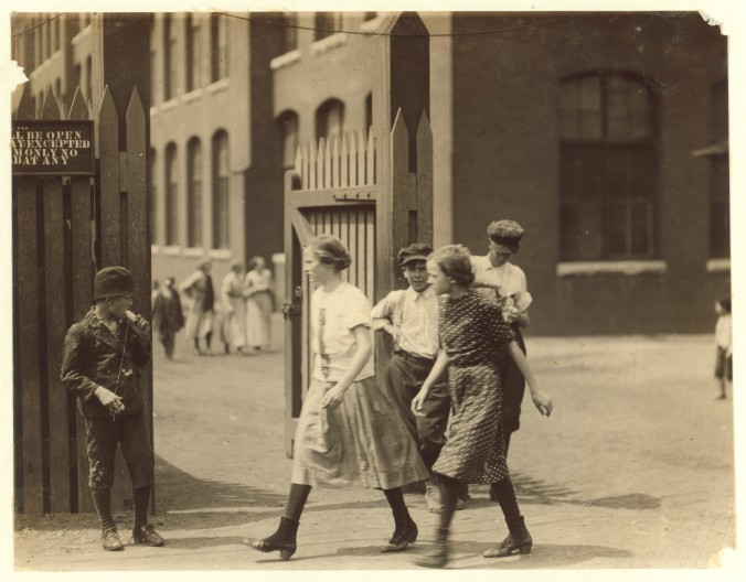 Photo of a group of young girls passing by the fence of the Mill