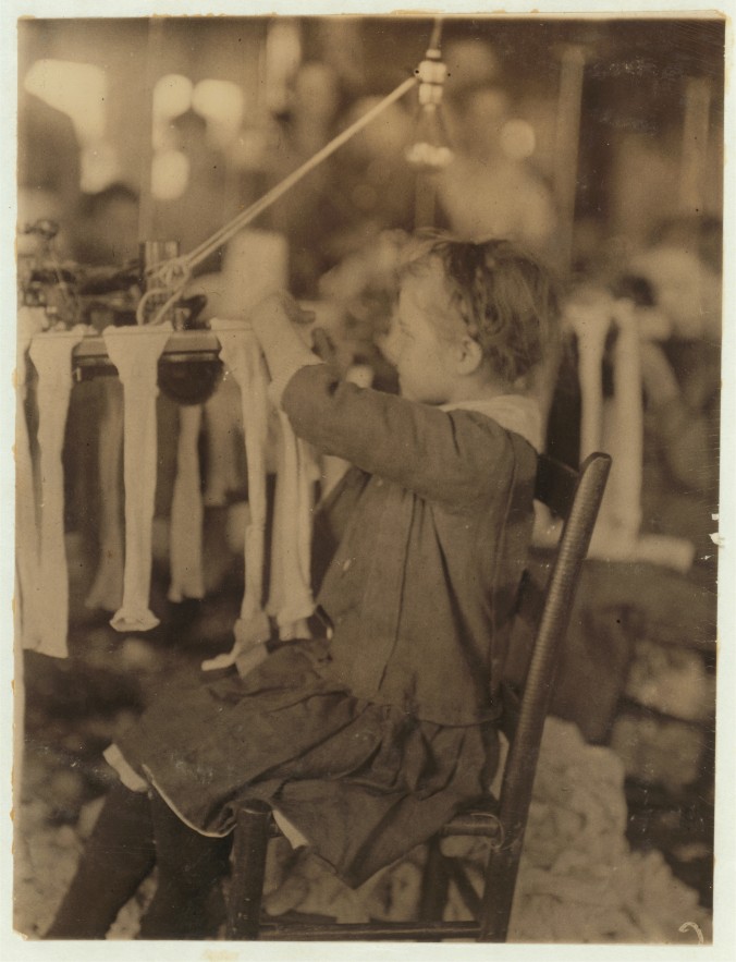 Photo of a young girl working at a machine