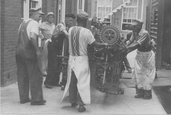 Photo of mill workers installing Loom installation