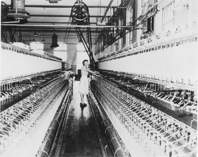 Photo of a Woman standing between machines