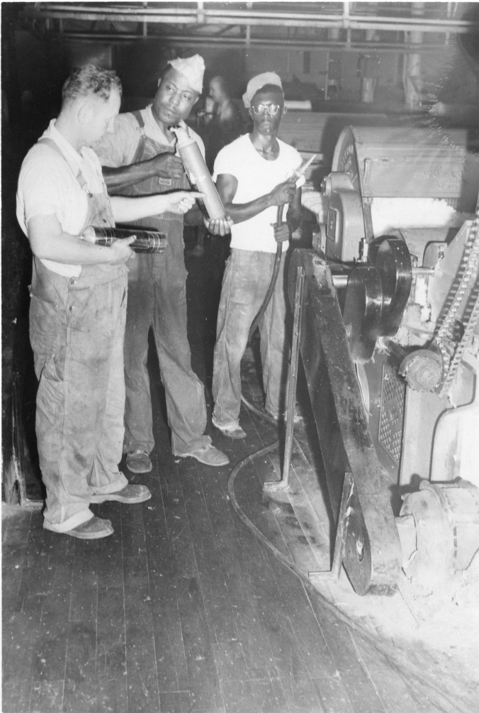 Photo of African American men working on a loom machine
