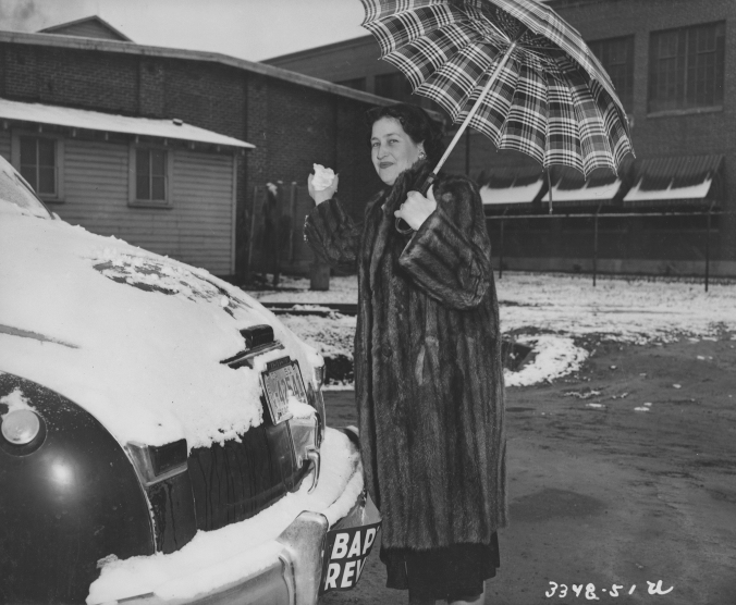 Photo of a woman in the snow in front of the Mill