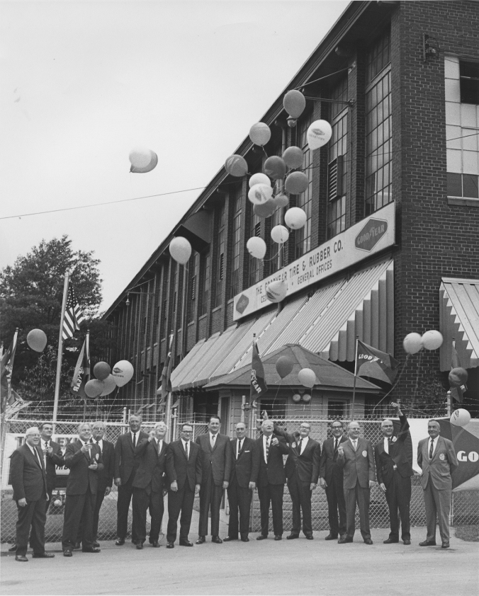 Photo of men in front of the Goodyear plant releasing ballons