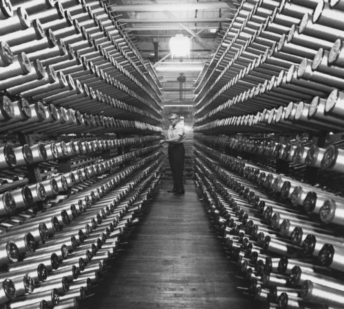 Photo of a Man between rows of spools