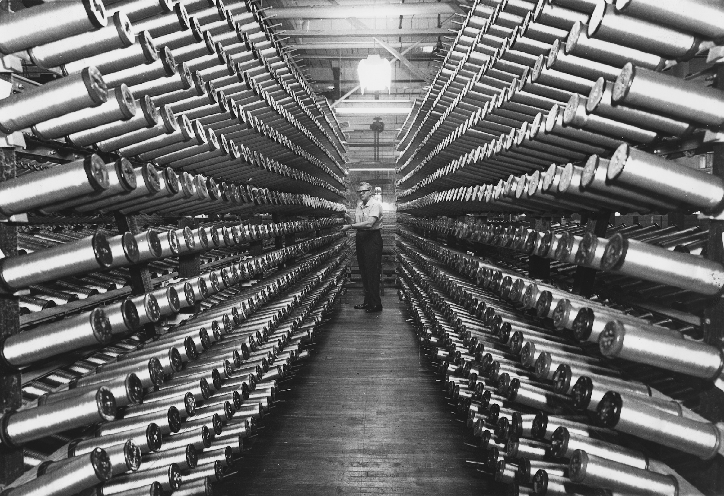 Photo of a Man between rows of spools