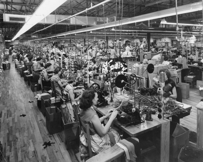 Photo of Women sew zippers in men's slacks at the Sewell Manufacturing Company plant in Temple, Georgia, in the summer of 1954